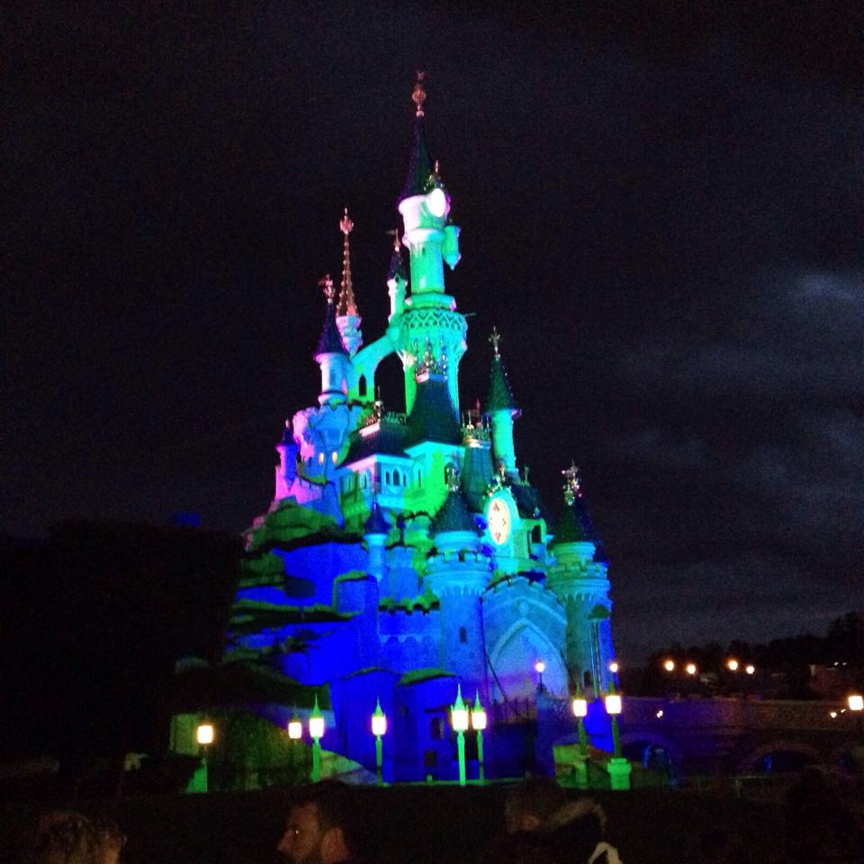 Sleeping Beauty Castle illuminated at night at Disneyland Paris