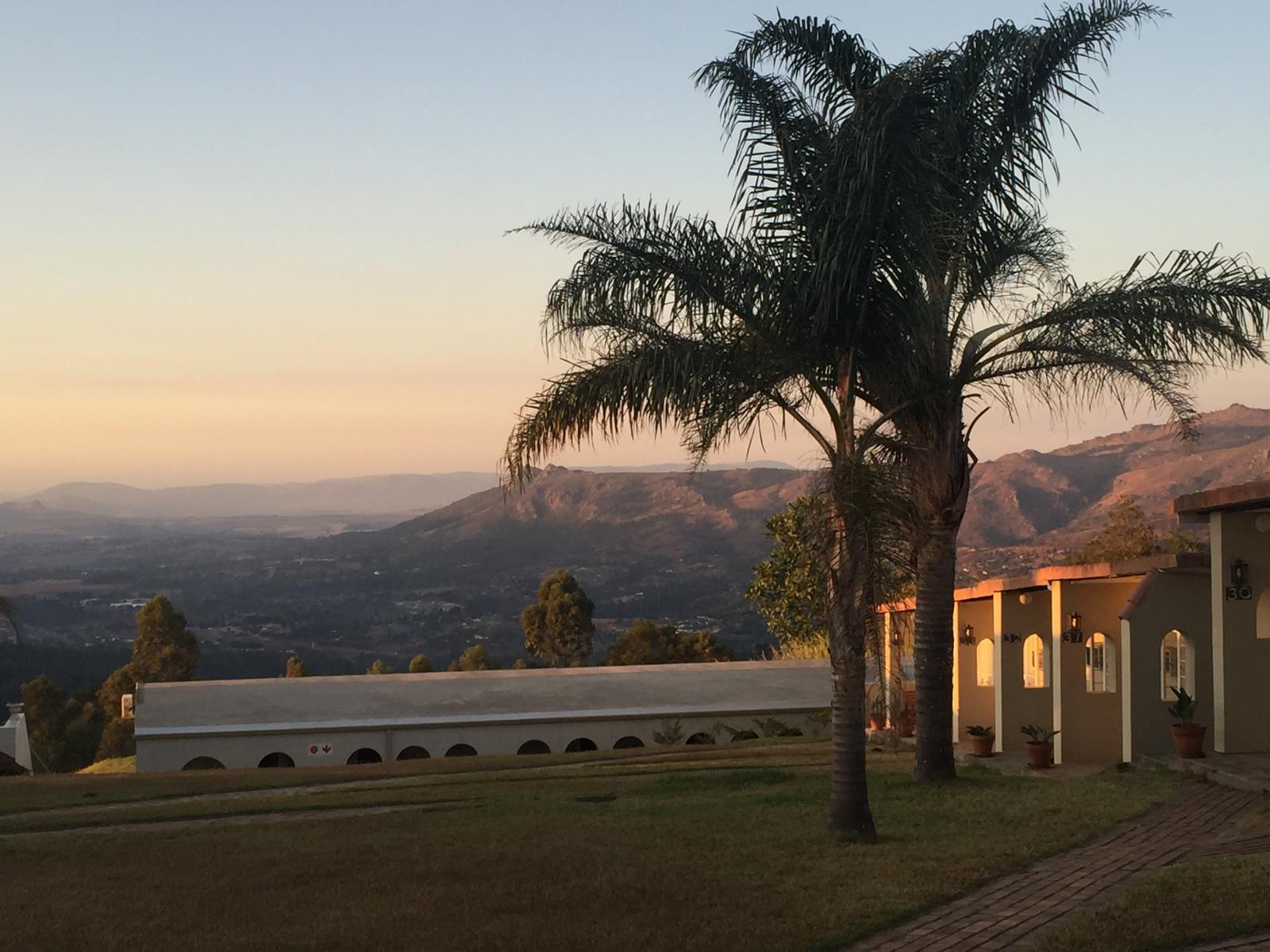 Eswatini sunset with palm trees — Two for the Row'd