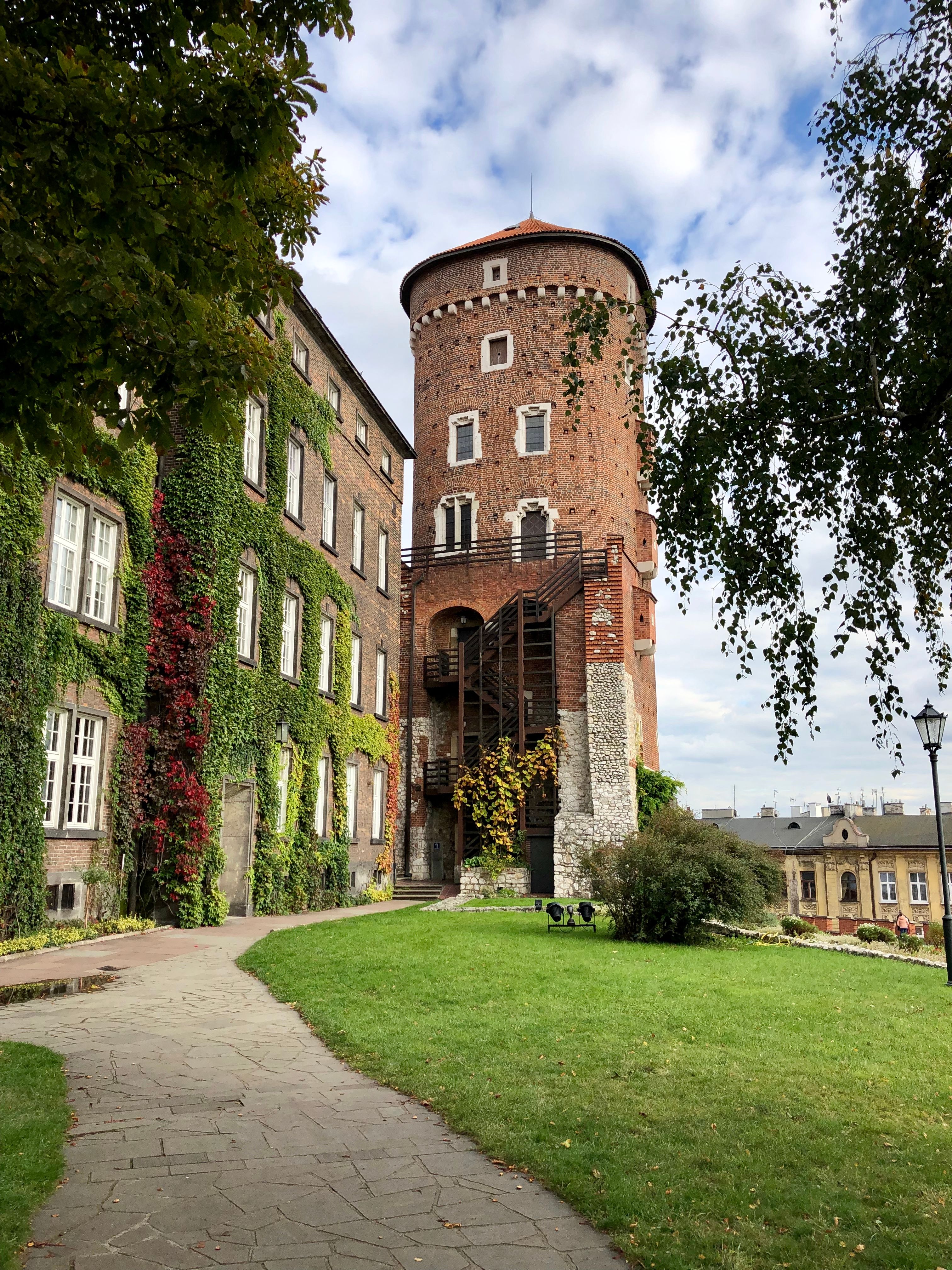 Historic brick gateway and trees in Kraków