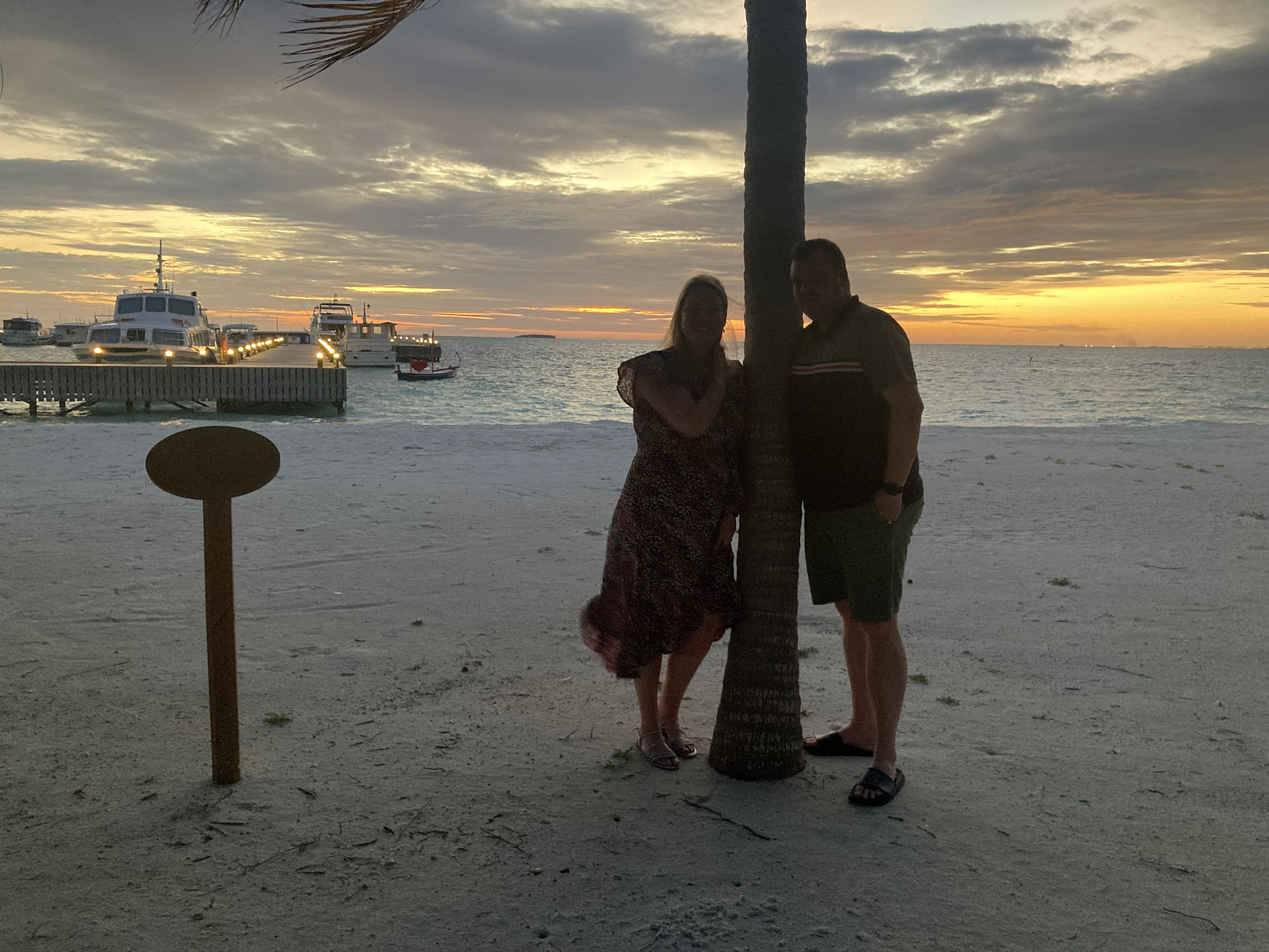 Couple on jetty at sunset Maldives — Two for the Row'd