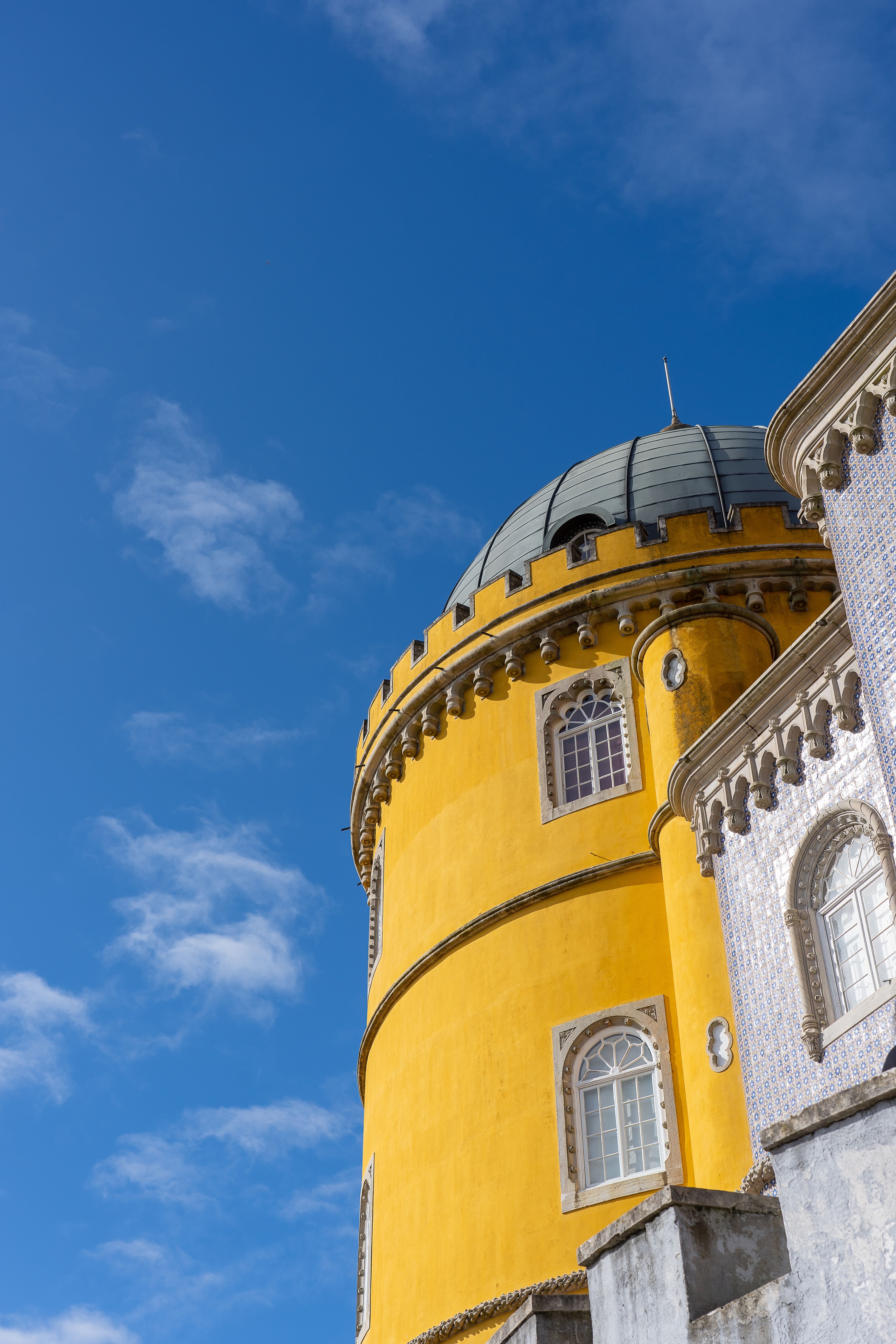 Yellow palace tower against a blue sky in Sintra, Portugal