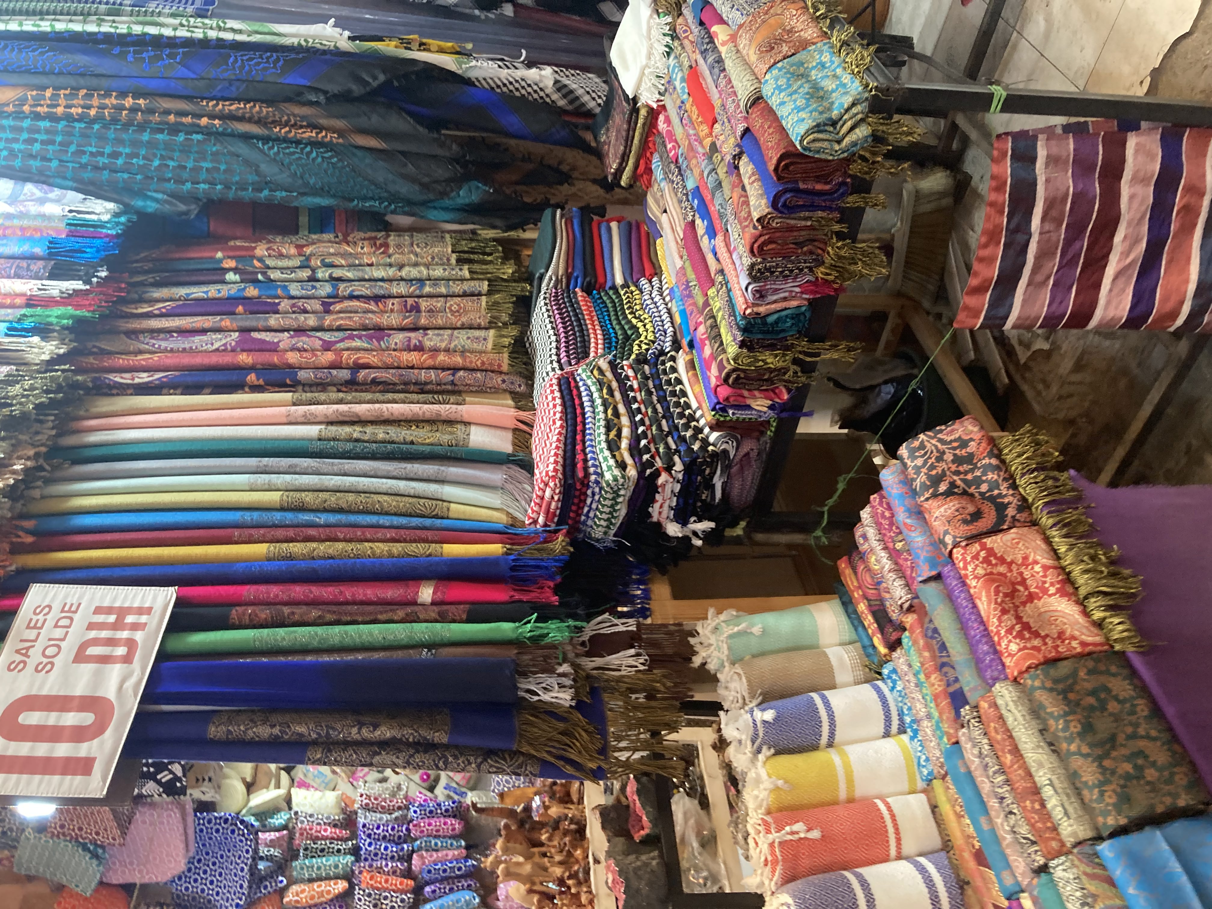 Colourful textiles and stalls in the souks of Marrakech, photographed during our February 2026 trip