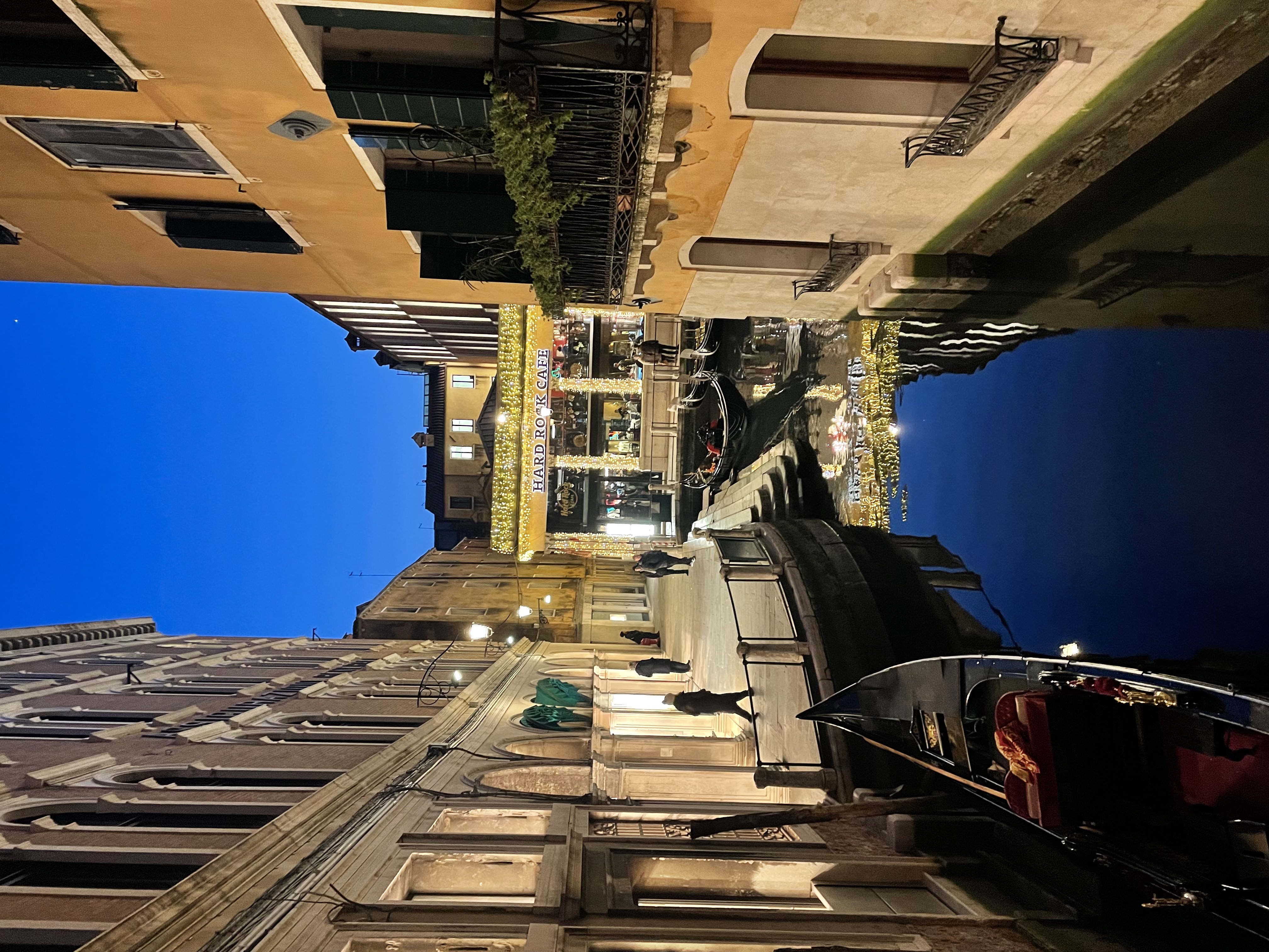A narrow canal between colourful Venetian buildings