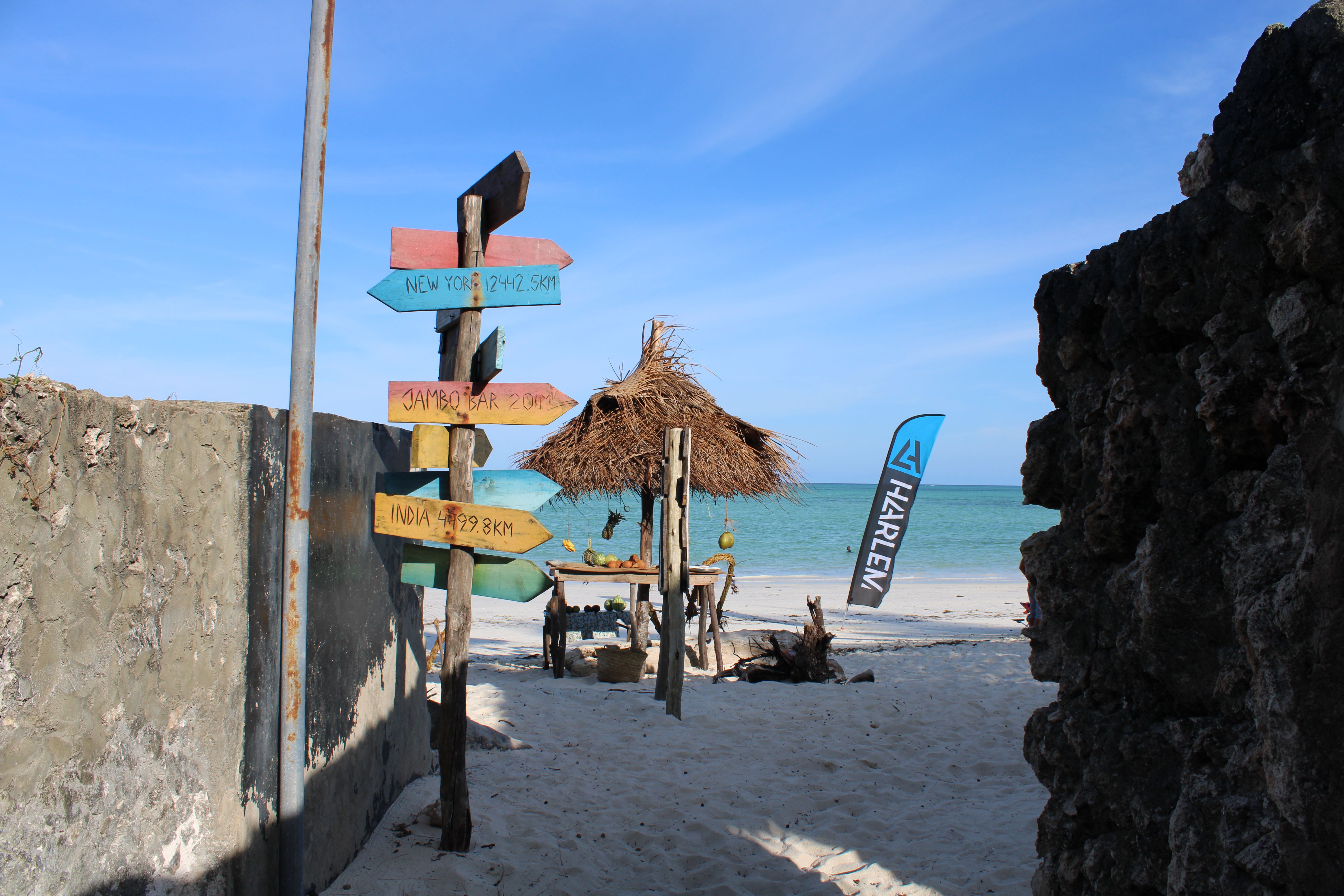 Beachside sign and turquoise sea in Zanzibar